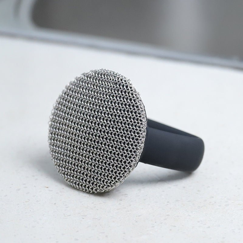 316 Stainless Steel Cast Iron Scrubber with Handle on a countertop, showcasing its cleaning mesh surface.